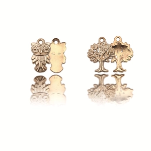 Detailed view of gold owl and tree of life alloy pendants for DIY necklace crafting