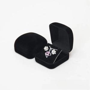 Black velvet jewelry gift box showing a silver necklace with pink heart pendant and earrings