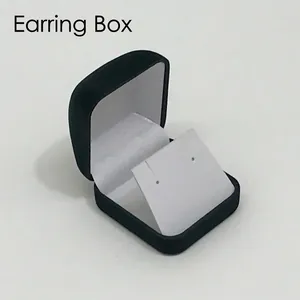 Detail of black velvet jewelry box for earrings featuring a white slanted inner insert card