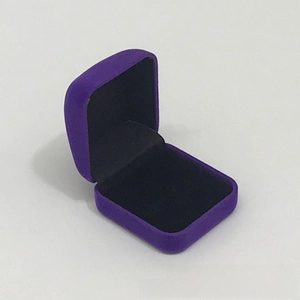 Close-up of purple velvet jewelry box with black lining for rings or earrings