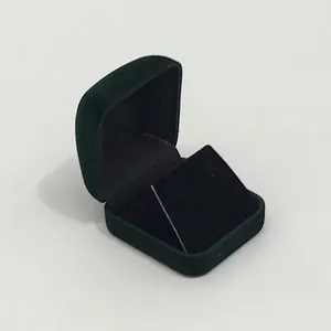 Macro detail of dark green velvet jewelry box showing soft inner lining and premium texture