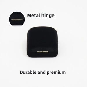 Detail of premium black velvet jewelry box featuring a durable metal hinge mechanism