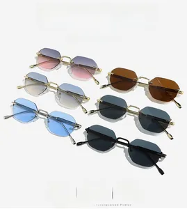 Flat lay of rimless polygonal sunglasses set with gold metal frames in six colors