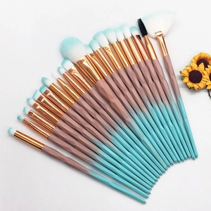 Flat lay of 20pcs makeup brushes with diamond gradient handles and sunflower detail