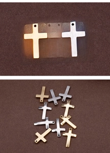Detailed view of polished metal cross pendants in gold and silver for DIY jewelry