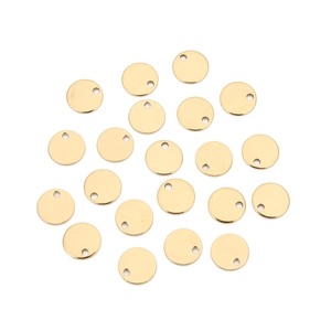 Detailed macro view of twenty small golden stainless steel round tags with pre-drilled holes