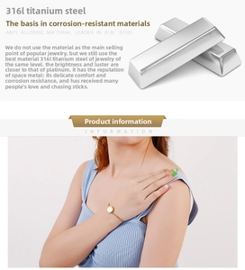 Detail of gold titanium steel bracelet featuring a round white enamel charm on model wrist