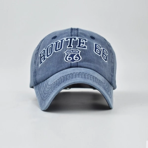 Close-up of vintage Route 66 embroidery on dark blue washed denim baseball cap