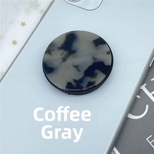 Close-up of tortoise shell pattern phone grip holder attached to a mobile device