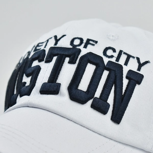 Macro view of 3D embroidery on white cotton baseball cap with Boston lettering
