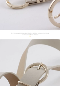 Gros plan d'une ceinture fine en cuir beige avec une boucle ronde en métal doré poli
