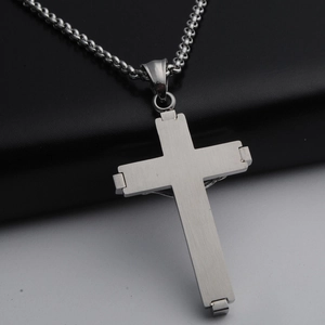 Minimalist silver stainless steel cross pendant necklace with a brushed metal finish