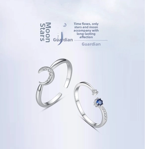 Close-up of silver moon and star ring set with blue zircon and adjustable band