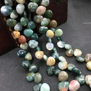Close-up of multicolored natural agate beads with irregular round shape for DIY jewelry