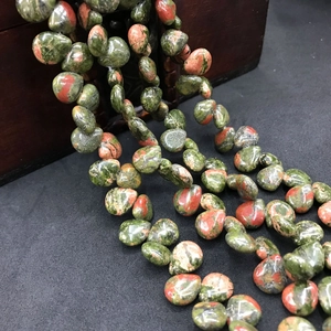 Close-up of natural unakite stone beads in teardrop shape for DIY jewelry making