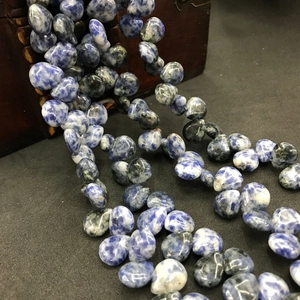 Macro detail of natural blue and white striped agate stone beads for DIY jewelry making