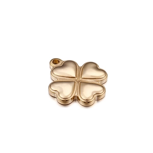 Polished gold metal four-leaf clover pendant accessory with top ring on white background