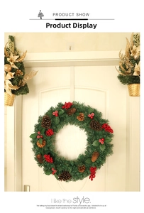 Detailed view of Christmas wreath featuring red berries and pine cones on green pine needles