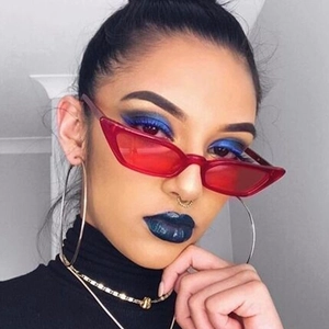 Stylish red cat-eye sunglasses with transparent frame worn by a model in close-up shot