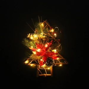 Lighted Christmas wreath with red poinsettia and pine cones on a wooden frame