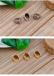 Close-up of gold and silver striped pendant clasps for DIY jewelry making on wood