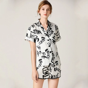 Detail of short-sleeve pajama set with cursive letter print and lapel collar