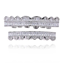 Close-up of hip hop silver grillz set with cross texture and shimmering zircon stones