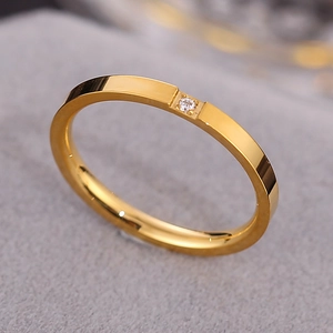 Minimalist gold titanium steel ring featuring a single small round clear crystal