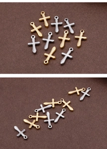 Detail of twisted texture on gold and silver stainless steel cross pendants