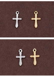 Detailed view of silver and gold cross pendants with intricate twisted rope textures