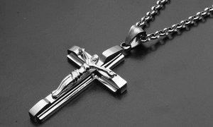 Macro shot of a tiered silver cross pendant featuring a 3D crucifix in stainless steel
