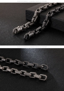 Detail of heavy stainless steel punk chain with intricate vintage embossed patterns
