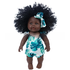 Detail of African reborn baby doll with curly afro hair and tropical leaf romper