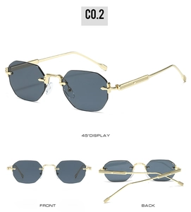 Detail view of rimless octagonal sunglasses with gold metal temples and grey cut-edge lenses