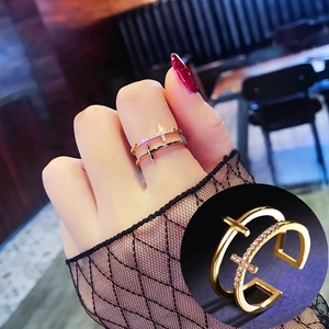 Detailed close-up showing micro-pave zircon on double-layer cross open ring in gold