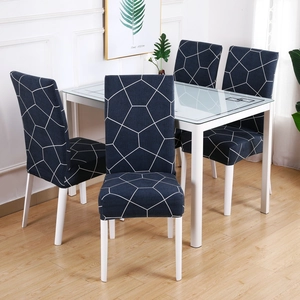 Close-up of dark blue elastic chair cover with white geometric lines in a modern dining room