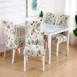 Modern white stretch dining chair covers with floral pattern shown in a set of four