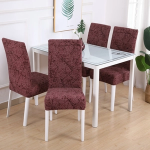 Close-up of wine red stretch chair covers with black line texture on dining chairs