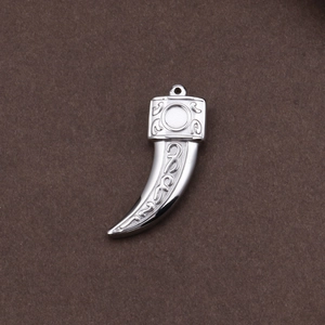 Gothic silver stainless steel wolf tooth pendant with ornate relief on dark surface