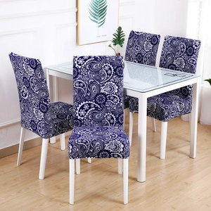 Dining room scene showing blue and white paisley pattern stretch chair covers on four seats