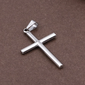 Polished silver stainless steel cross pendant with single hole on brown texture surface