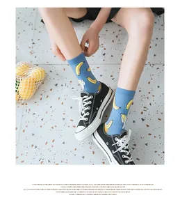 Blue cotton crew socks featuring cute banana print styled with black canvas sneakers