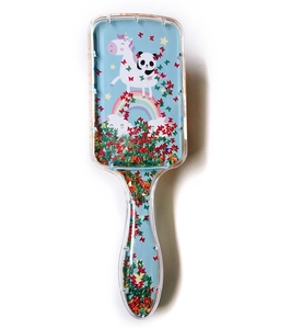 Detail of blue unicorn panda hairbrush with sparkling glitter sequins in transparent handle