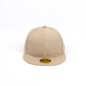 Close-up of beige flat brim baseball cap showing six-panel cotton twill and size sticker