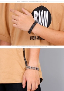 Detail of stainless steel biker chain bracelets in black and silver finishes on wrist
