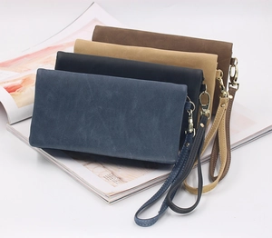 Close-up of matte leather long wallets in multiple colors with gold metal buckles