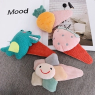 Close-up of plush hair clips in carrot, strawberry, flower, and crocodile shapes