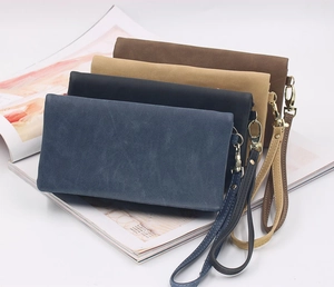 Group of long wallets in navy, black, camel, and brown with matching wrist straps