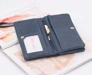 Interior detail of dusty blue long wallet showing multiple card slots and zipper pocket