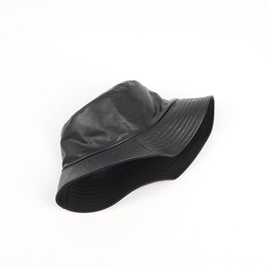 Close-up of the smooth black PU leather texture and stitched brim on bucket hat